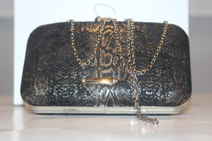 This bag is handcrafted with Italian l METALLIC SILVER SNAKE Print On Black Suede, Thin, Soft Italian Goatskin Goat Leather. The bag is topped with a silver-toned owl and a silver-tone frame.&nbsp;&nbsp. This eye-catching clutch bag is the ultimate evening and day accessory, which&nbsp;can be carried by hand or worn draped over the shoulder with the detachable chain strap.
Our Black Owl&nbsp; Woman Clutch Bag is whimsical and elegant.  
