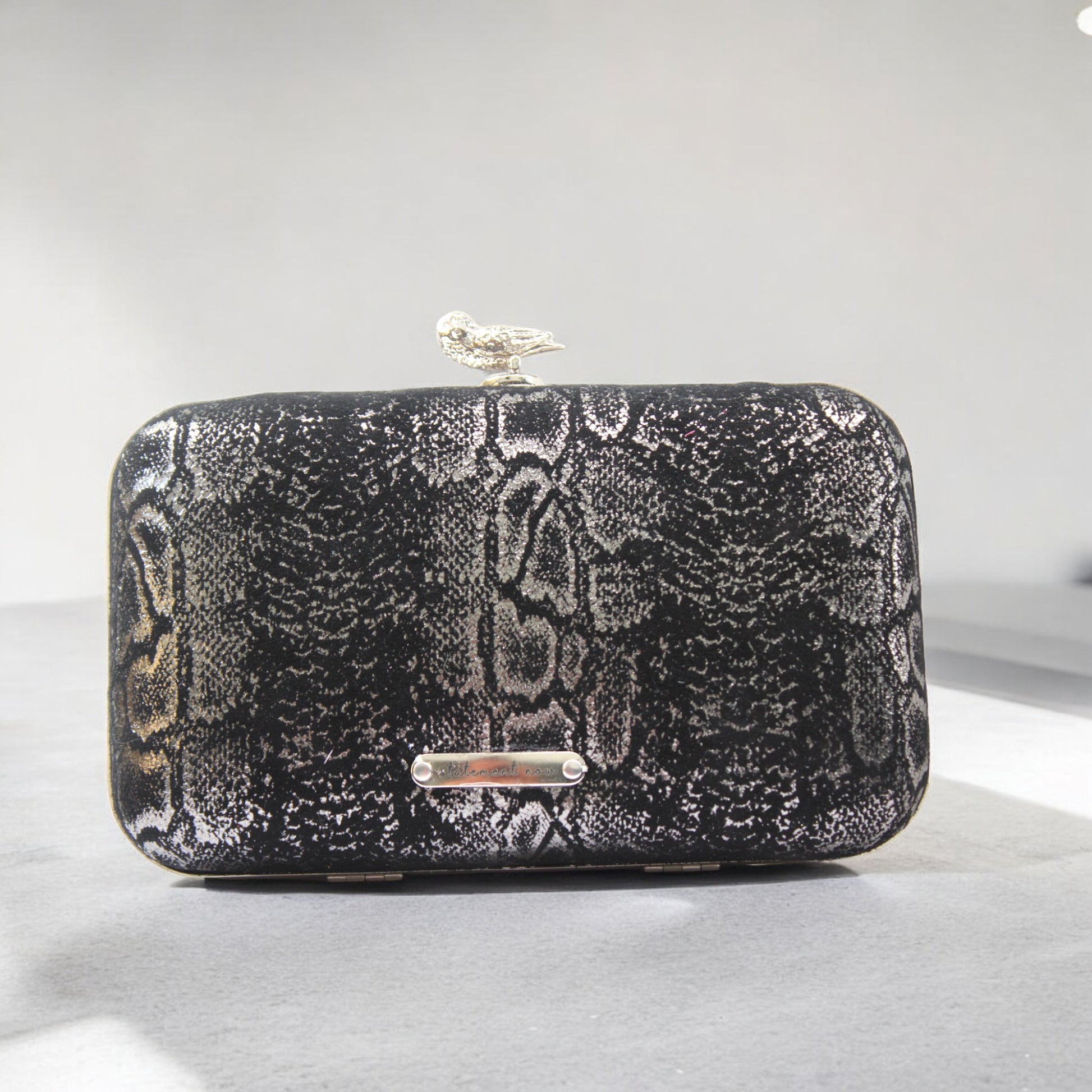 This bag is handcrafted with Italian l METALLIC SILVER SNAKE Print On Black Suede, Thin, Soft Italian Goatskin Goat Leather. The bag is topped with a silver-toned owl and a silver-tone frame.&nbsp;&nbsp. This eye-catching clutch bag is the ultimate evening and day accessory, which&nbsp;can be carried by hand or worn draped over the shoulder with the detachable chain strap.
Our Black Owl Woman Clutch Bag is whimsical and elegant. It is a rectangular clutch bag. 
