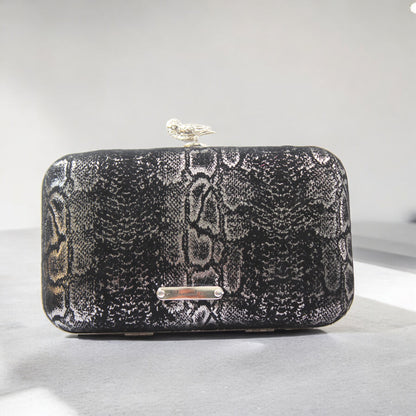 This bag is handcrafted with Italian l METALLIC SILVER SNAKE Print On Black Suede, Thin, Soft Italian Goatskin Goat Leather. The bag is topped with a silver-toned owl and a silver-tone frame.&nbsp;&nbsp. This eye-catching clutch bag is the ultimate evening and day accessory, which&nbsp;can be carried by hand or worn draped over the shoulder with the detachable chain strap.
Our Black Owl Woman Clutch Bag is whimsical and elegant. It is a rectangular clutch bag. 
