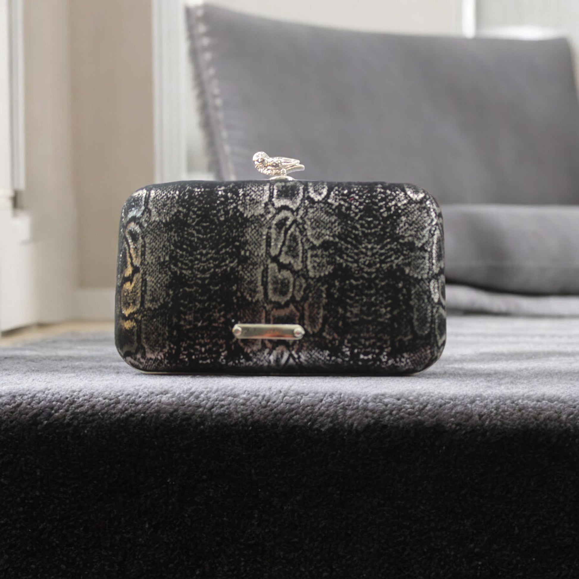 This bag is handcrafted with Italian l METALLIC SILVER SNAKE Print On Black Suede, Thin, Soft Italian Goatskin Goat Leather. The bag is topped with a silver-toned owl and a silver-tone frame.&nbsp;&nbsp. This eye-catching clutch bag is the ultimate evening and day accessory, which&nbsp;can be carried by hand or worn draped over the shoulder with the detachable chain strap.
Our Black Owl&nbsp; Woman Clutch Bag is whimsical and elegant. It is a rectangular clutch bag made especially for women who want to be 
