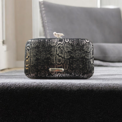 This bag is handcrafted with Italian l METALLIC SILVER SNAKE Print On Black Suede, Thin, Soft Italian Goatskin Goat Leather. The bag is topped with a silver-toned owl and a silver-tone frame.&nbsp;&nbsp. This eye-catching clutch bag is the ultimate evening and day accessory, which&nbsp;can be carried by hand or worn draped over the shoulder with the detachable chain strap.
Our Black Owl&nbsp; Woman Clutch Bag is whimsical and elegant. It is a rectangular clutch bag made especially for women who want to be 
