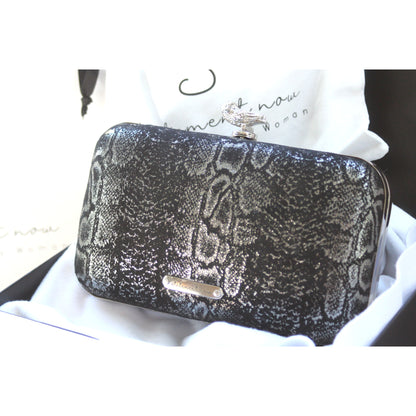This bag is handcrafted with Italian l METALLIC SILVER SNAKE Print On Black Suede, Thin, Soft Italian Goatskin Goat Leather. The bag is topped with a silver-toned owl and a silver-tone frame.&nbsp;&nbsp. This eye-catching clutch bag is the ultimate evening and day accessory, which&nbsp;can be carried by hand or worn draped over the shoulder with the detachable chain strap.
Our Black Owl&nbsp; Woman Clutch Bag is whimsical and elegant. It is a rectangular clutch bag. 
